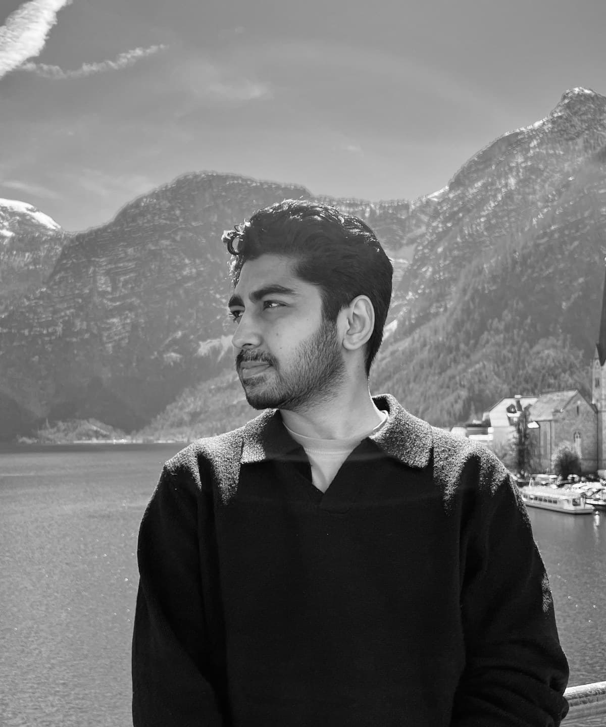 Saad by the lake in Hallstatt, Austria, with mountains behind him