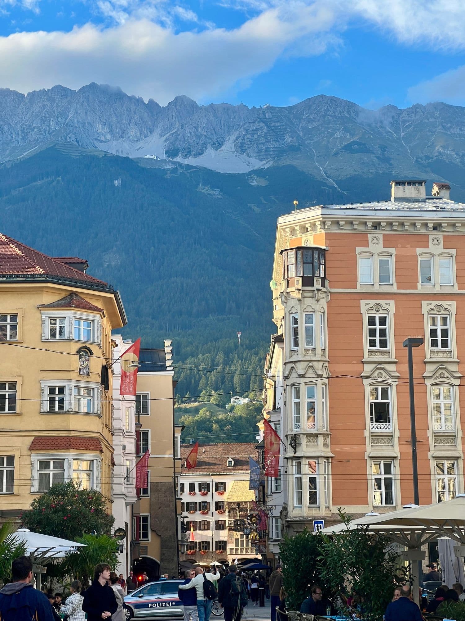 Colourful old town buildings framing a view of the mountains