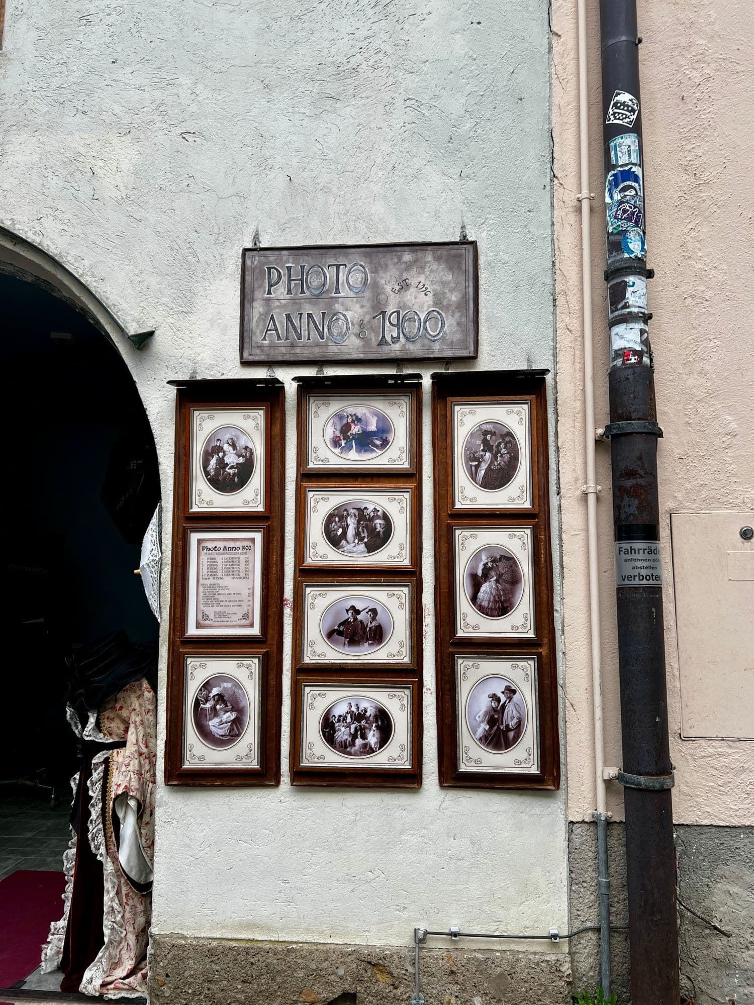 Old photo studio front with framed sepia portraits